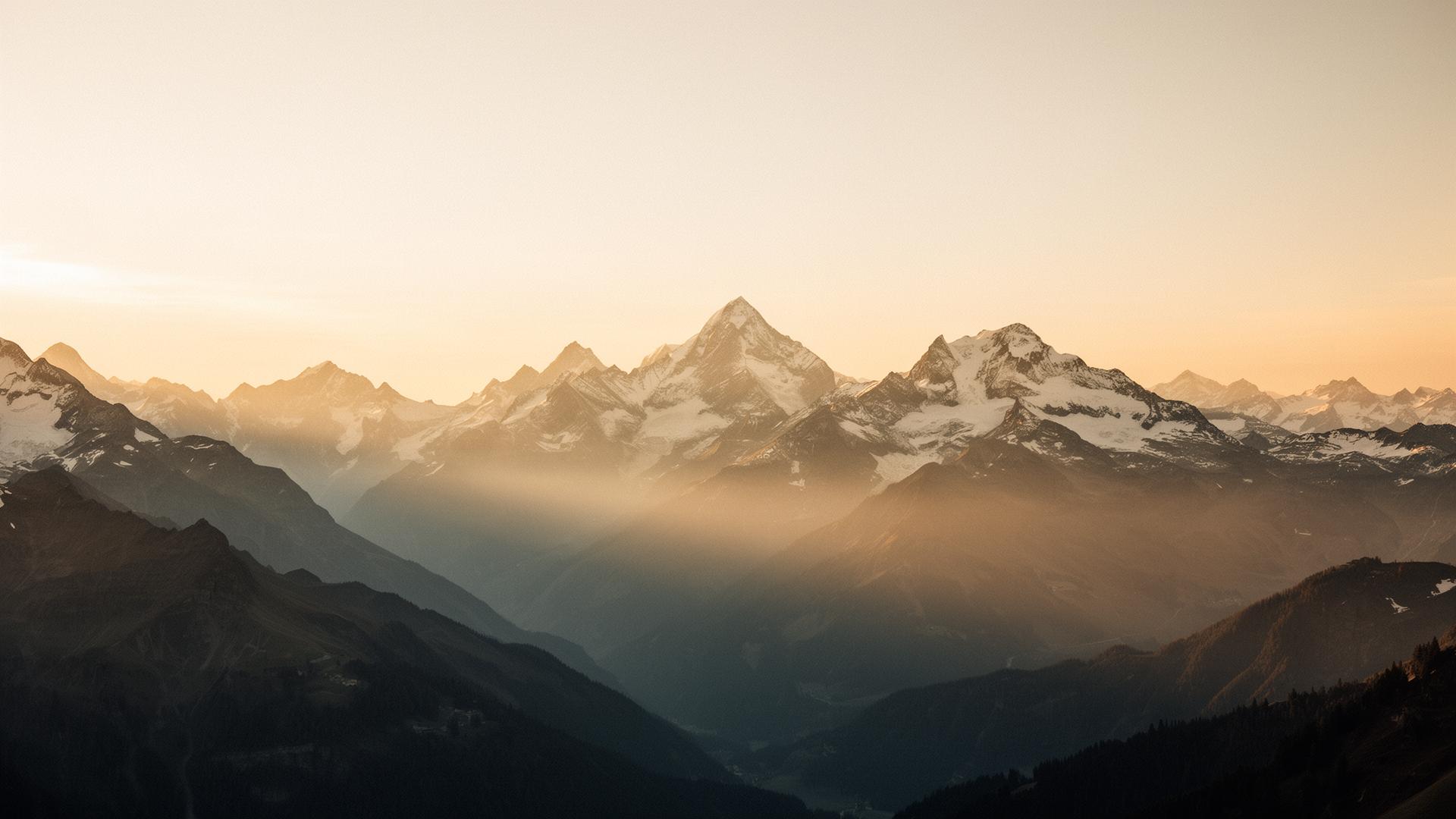Snow-capped peaks of the Swiss Alps at golden hour